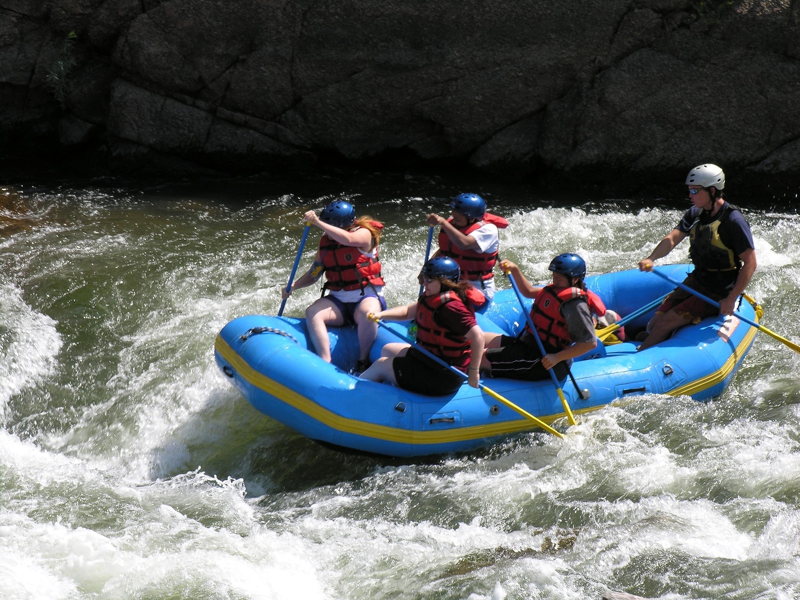 white water rafting on a river .